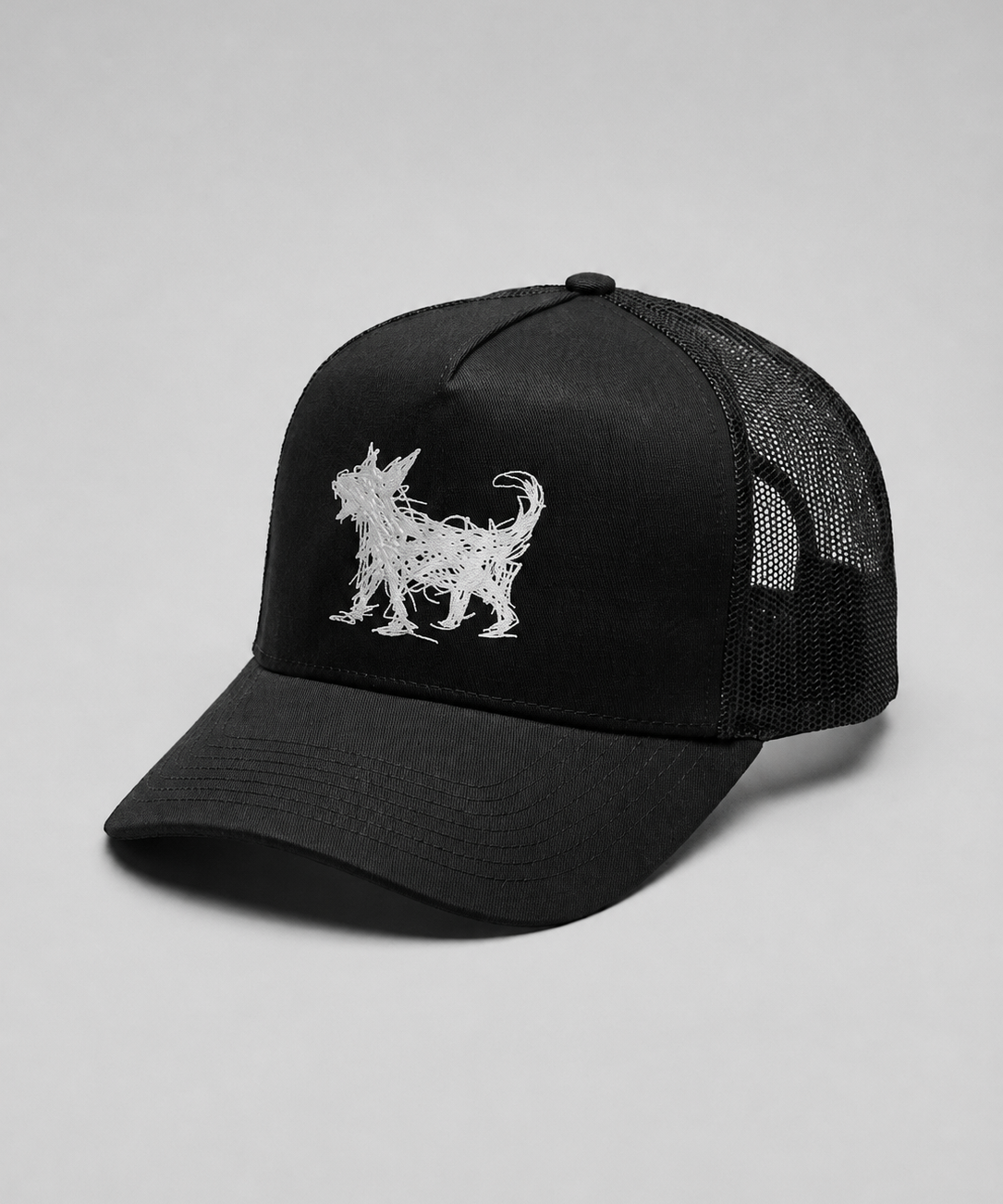 A black trucker-style cap with a white embroidered Beans dog silhouette on the front panel, shown against a neutral light gray background.