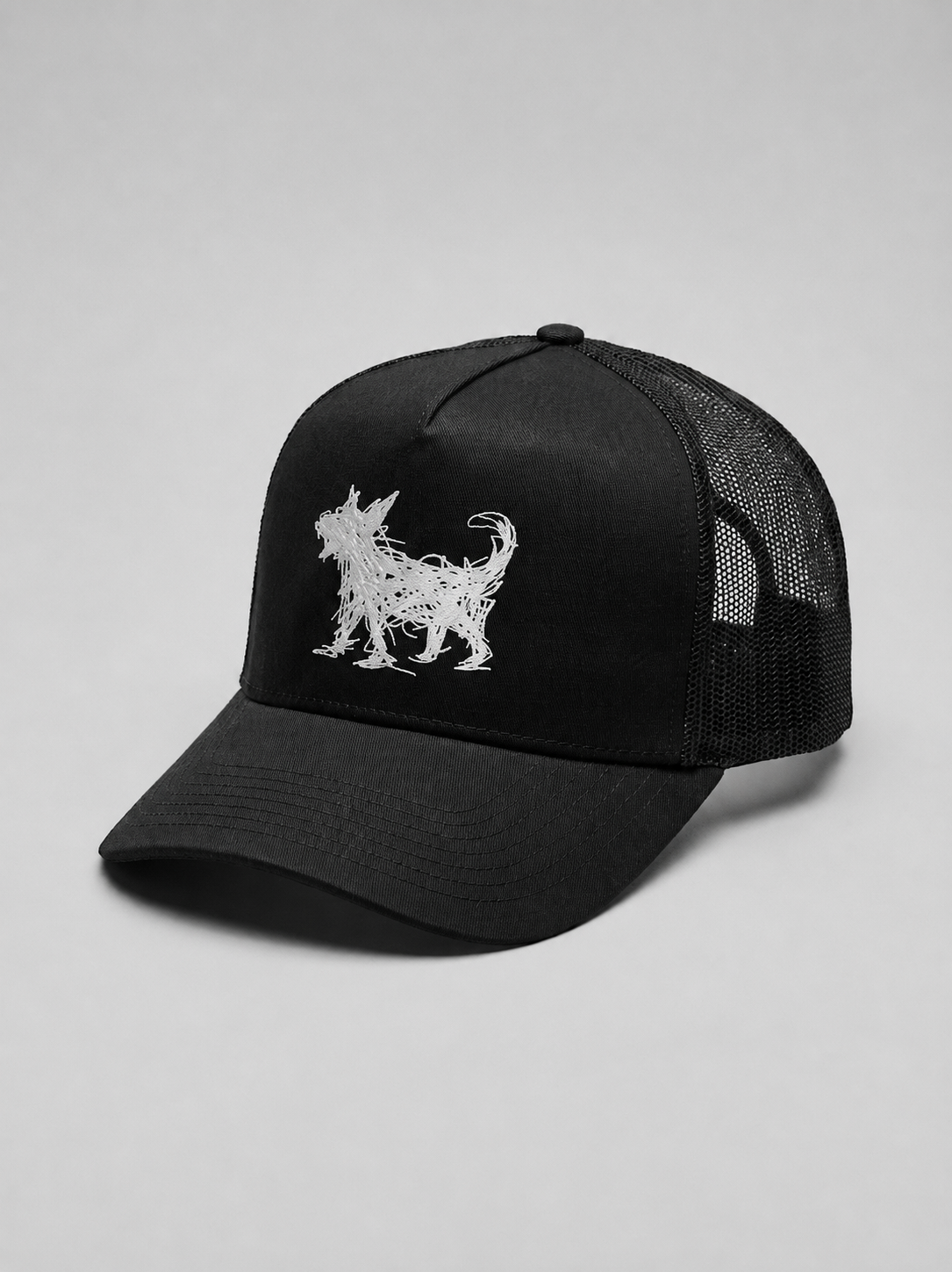 A black trucker-style cap with a white embroidered Beans dog silhouette on the front panel, shown against a neutral light gray background.