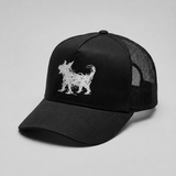 A black trucker-style cap with a white embroidered Beans dog silhouette on the front panel, shown against a neutral light gray background.